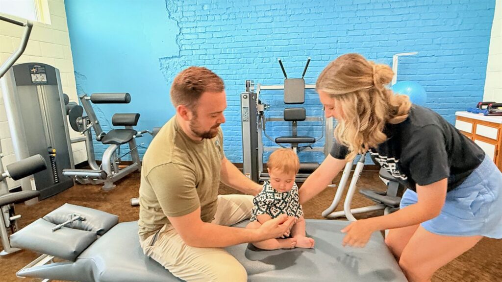 Dr. Crawford with a young patient and parent
